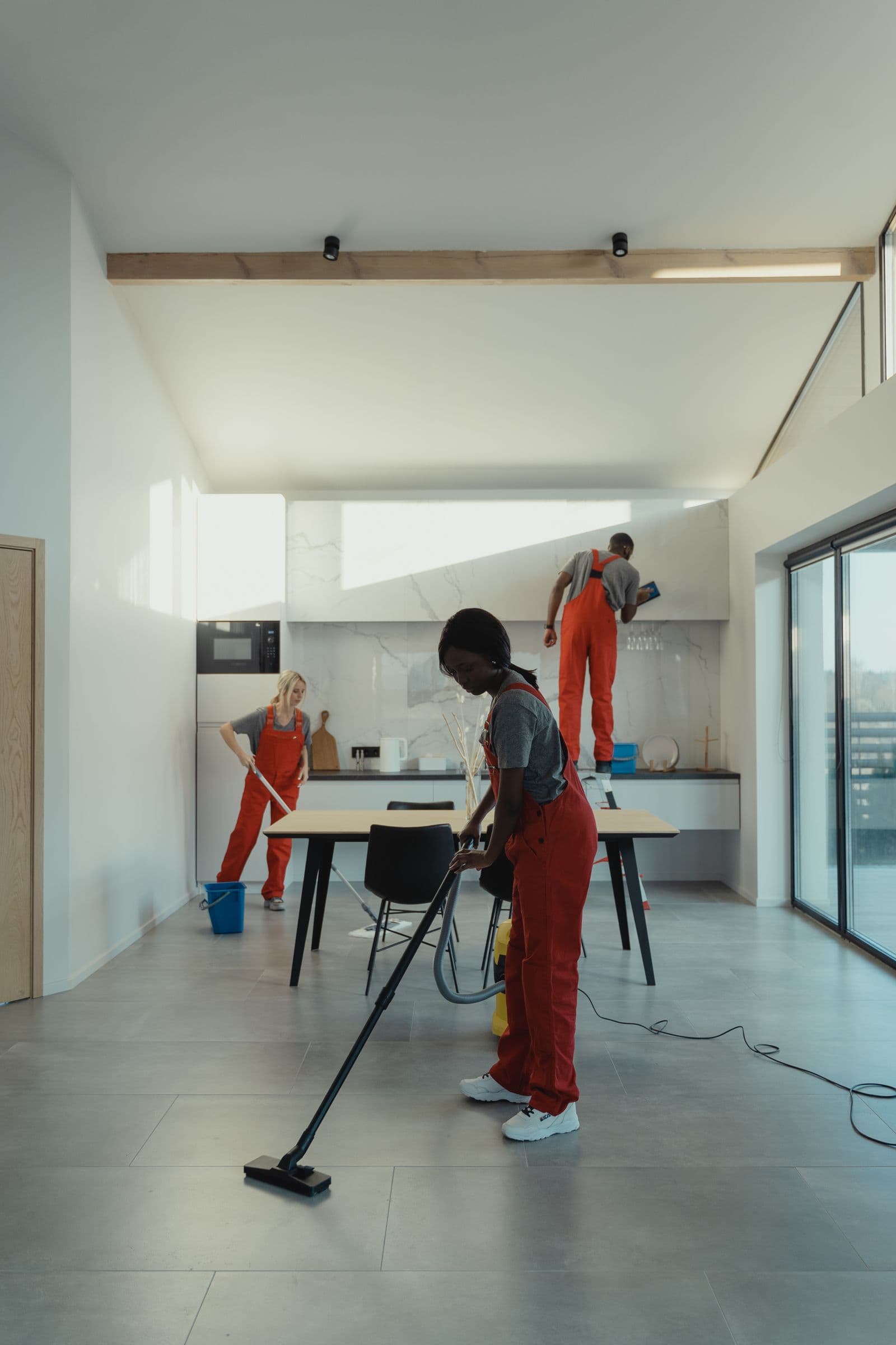 A professional cleaning team working in a modern home